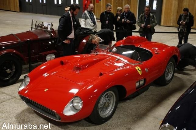 Visitors look at a red 1957 Ferrari 335 Sport Scaglietti model on display at the Paris Retromobile fair in Paris, France, February 5, 2016. REUTERS/Philippe Wojazer