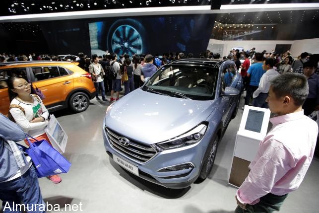 Visitors walk around the new Hyundai Tucson during Auto China 2016 auto show in Beijing