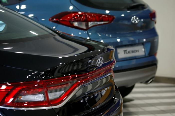 Hyundai Motor's sport utility vehicle (SUV) Tucson and sedan Granduer are seen at its dealership in Seoul